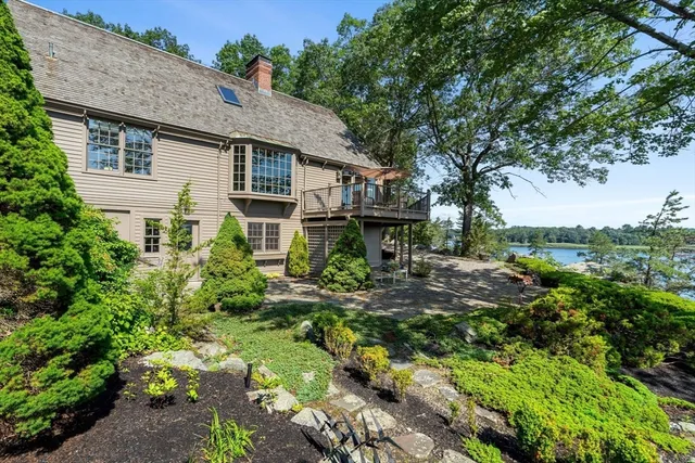 a backyard of a house with table and chairs