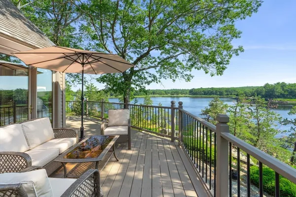 a view of balcony with furniture and umbrella