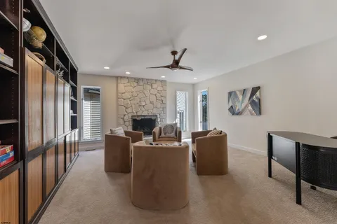a living room with furniture a window and kitchen view