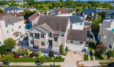 an aerial view of a house with a yard and garden