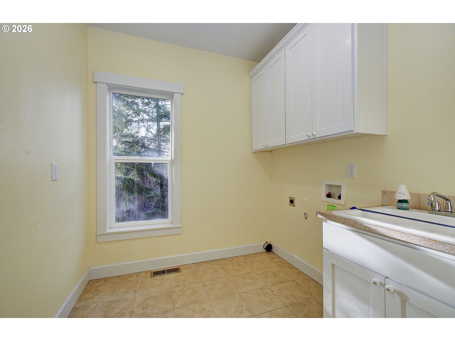 66743 Doetsch Road Deer Island, OR 97054 - Photo 9 of 43 a kitchen with a sink cabinets and a window