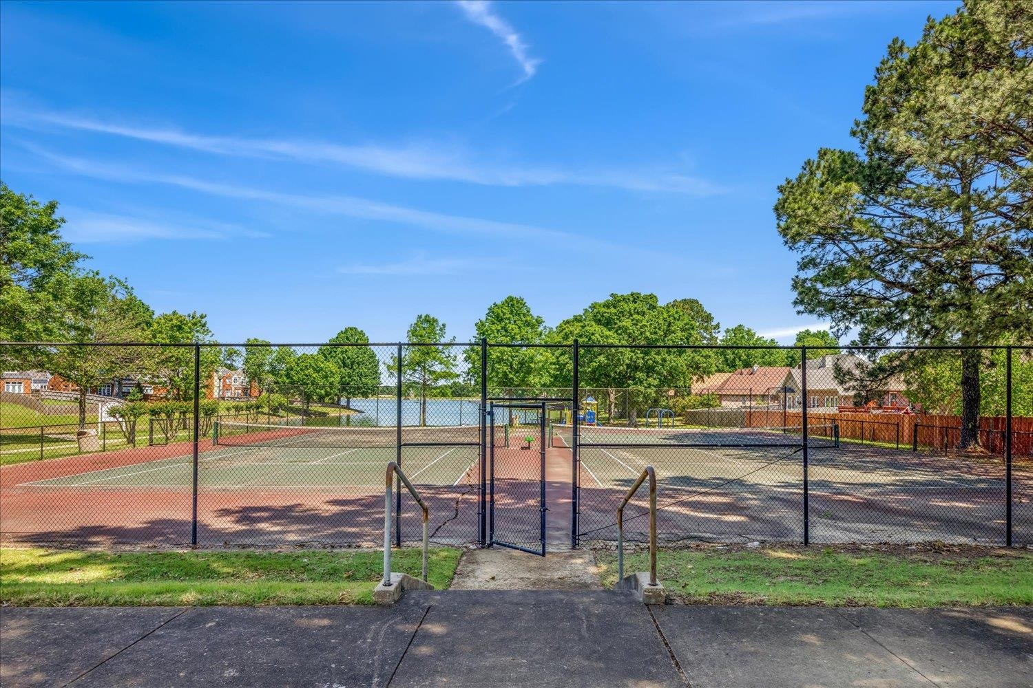 5128 Overview Ridge Memphis, TN 38141 - Photo 28 of 28 Hard-surfaced tennis courts featuring green and red playing areas, surrounded by chain-link fencing