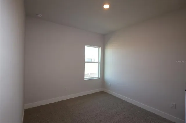 a aerial view of a house with swimming pool and outdoor seating
