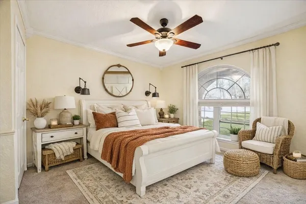 a bedroom with a large bed and a chandelier