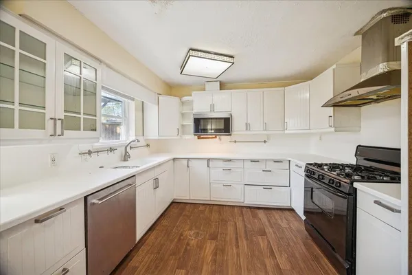 a kitchen with cabinets oven and a sink