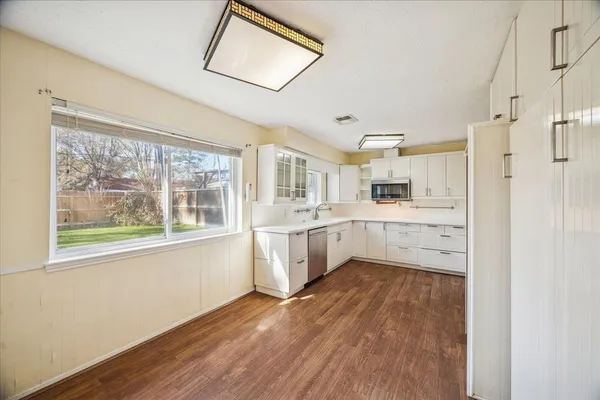 a kitchen with a refrigerator a sink and a window