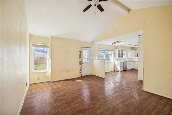a view of a livingroom with wooden floor and a ceiling fan