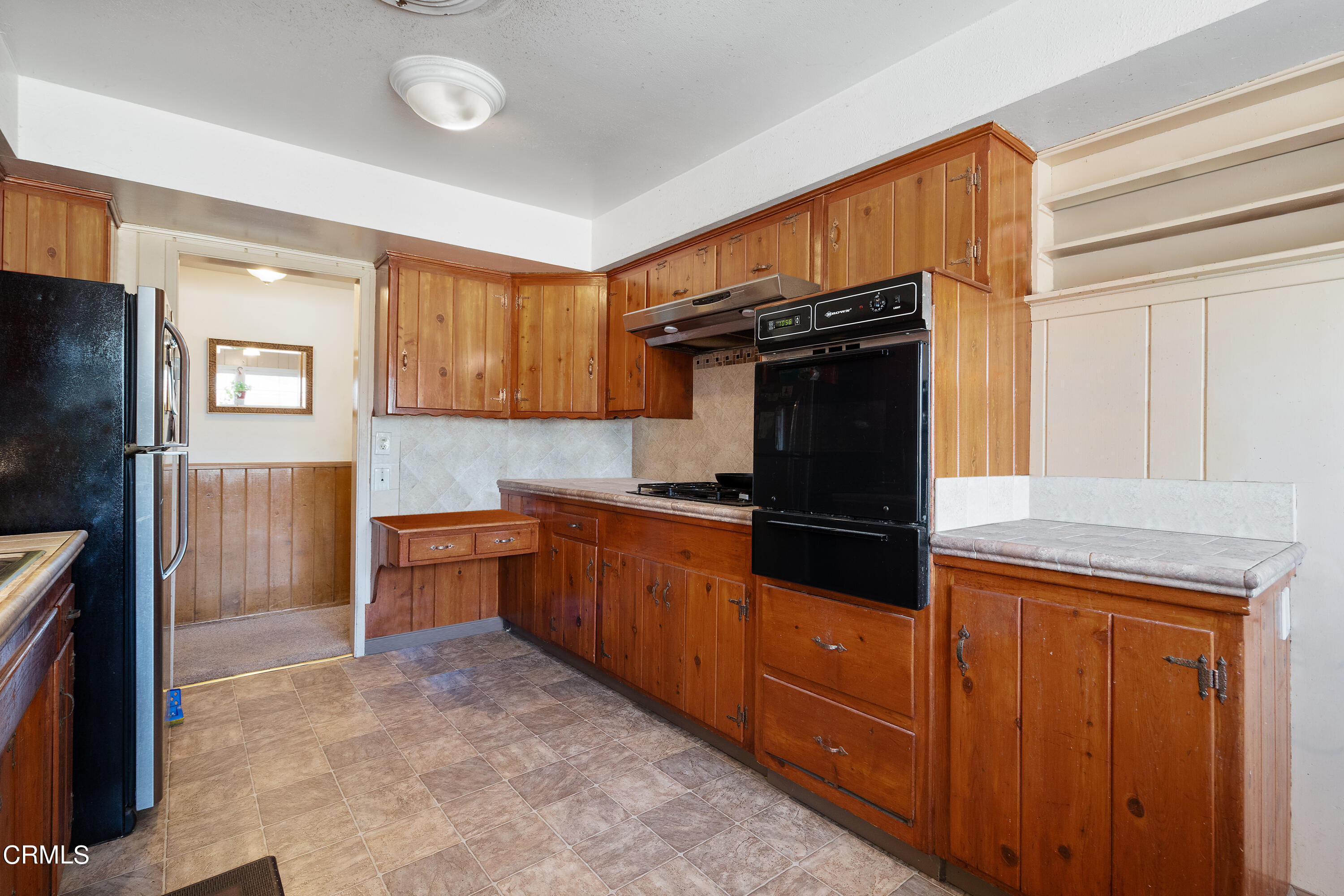 4161 Eve Road Simi Valley, CA 93063 - Photo 7 of 27 a kitchen with granite countertop a refrigerator and a stove top oven