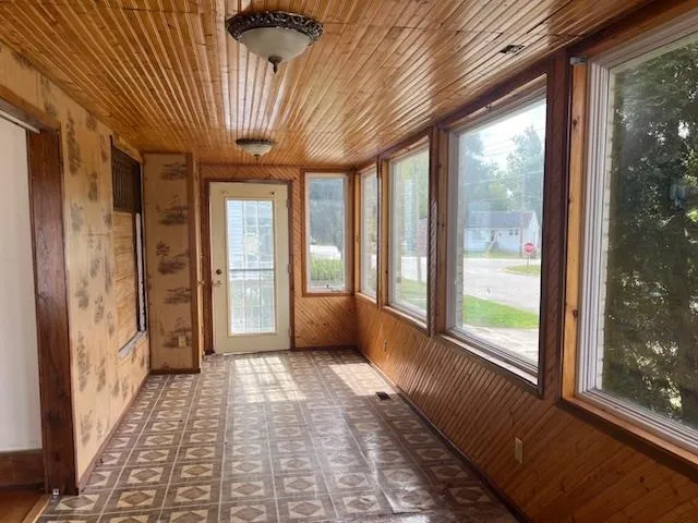 an empty room with closet and fan