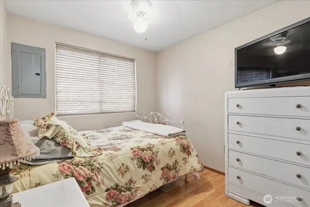 a bedroom with a bed and flat screen tv