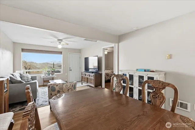 a living room with lots of furniture and a view of kitchen