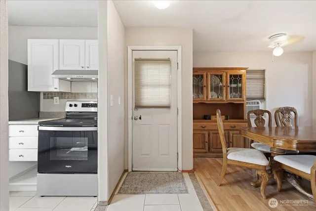 a kitchen with a refrigerator and cabinets
