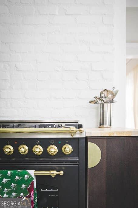 449 Greenwood Avenue Northeast, Unit 1 Atlanta, GA 30308 - Photo 13 of 27 a stove top oven sitting inside of a kitchen