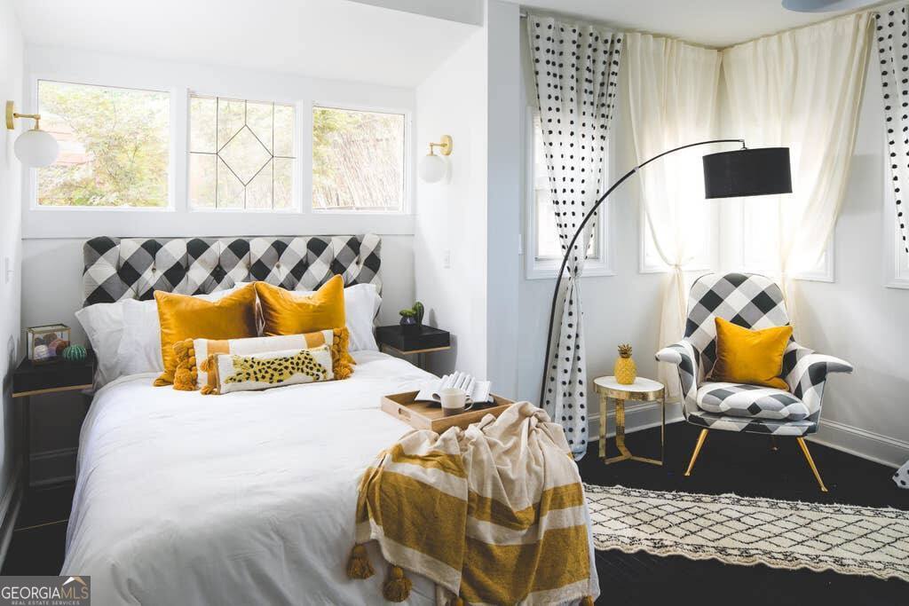 449 Greenwood Avenue Northeast, Unit 1 Atlanta, GA 30308 - Photo 14 of 27 a bedroom with a bed and wooden floor