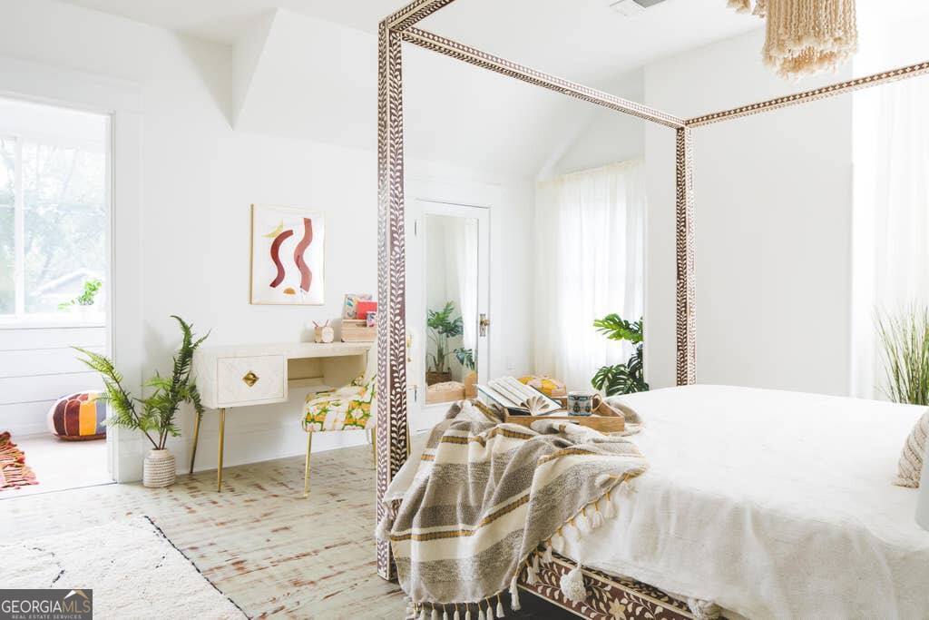 449 Greenwood Avenue Northeast, Unit 1 Atlanta, GA 30308 - Photo 20 of 27 a bed room with a bed and a table