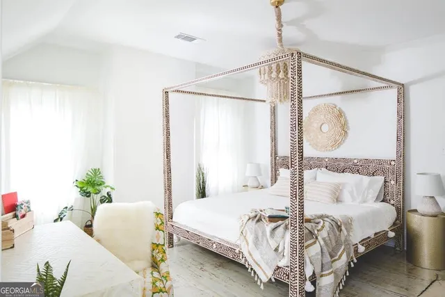 a bedroom with a bed and a chandelier