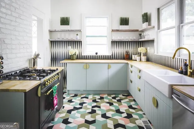 a kitchen with granite countertop a stove and a sink