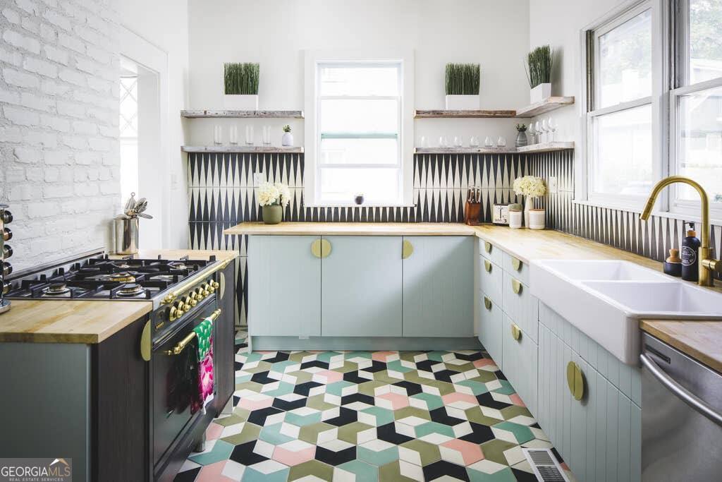 449 Greenwood Avenue Northeast, Unit 1 Atlanta, GA 30308 - Photo 5 of 27 a kitchen with granite countertop a stove and a sink