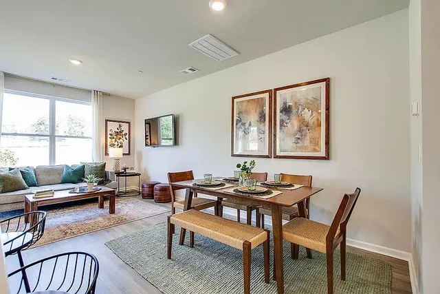 a dining room with furniture and window