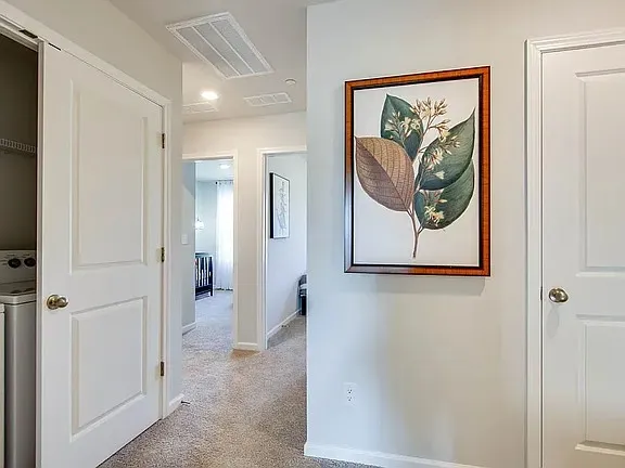 a view of a hallway with paintings on the wall