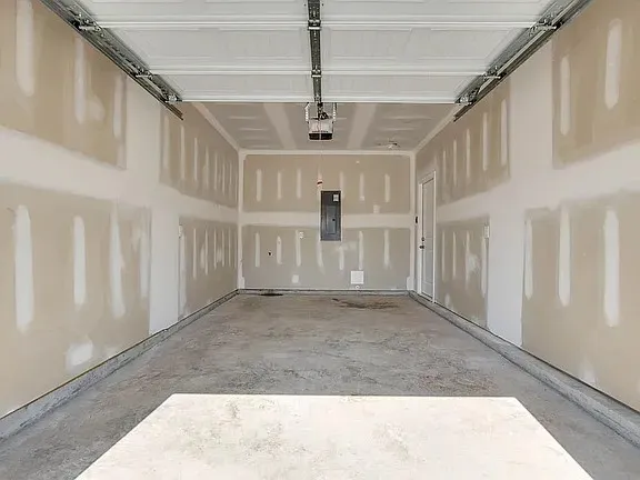 a view of a hallway with a white walls and stairs