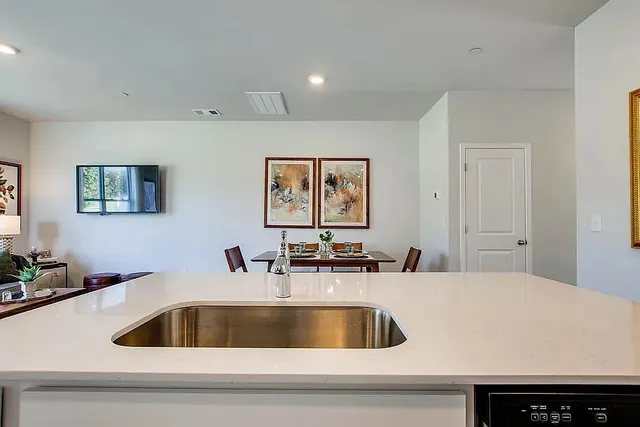 a kitchen with a sink and a refrigerator