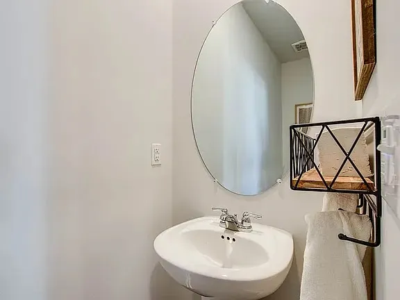 a bathroom with a sink and mirror