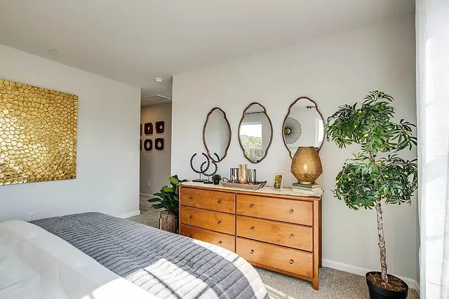 a bedroom with a bed and a potted plant