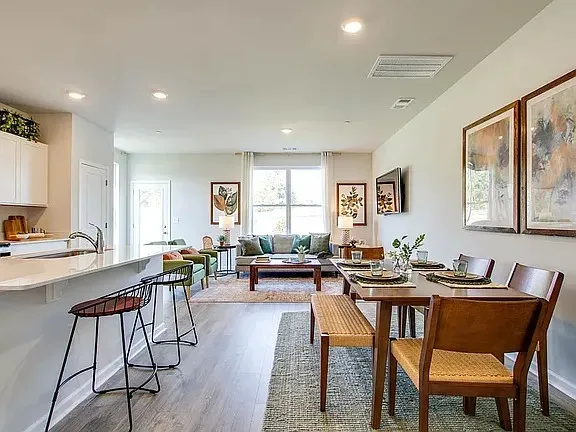 a view of a dining room with furniture window and wooden floor