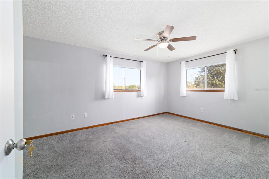 8329 Southwest 105th Place Ocala, FL 34481 - Photo 15 of 39 an empty room with windows and fan
