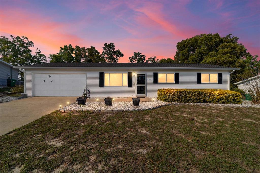 8329 Southwest 105th Place Ocala, FL 34481 - Photo 2 of 39 a front view of a house with a yard