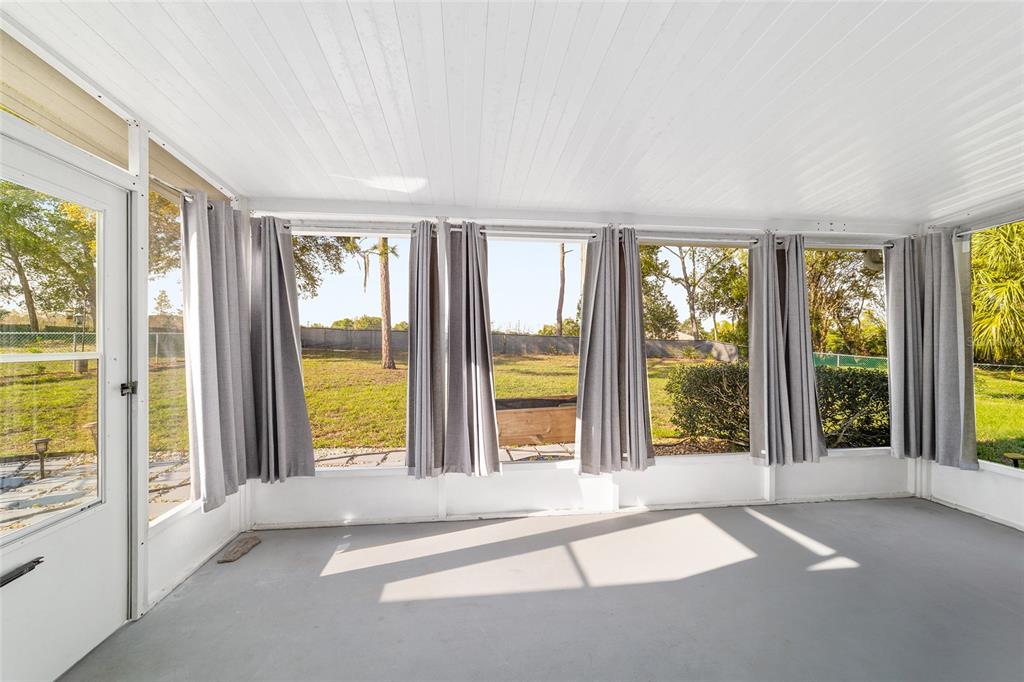 8329 Southwest 105th Place Ocala, FL 34481 - Photo 22 of 39 a view of an empty room with windows and pool table