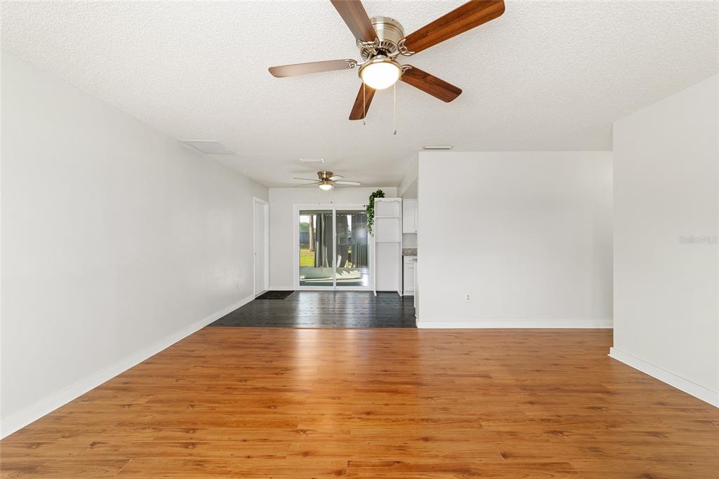 8329 Southwest 105th Place Ocala, FL 34481 - Photo 9 of 39 a view of empty room with wooden floor and fan