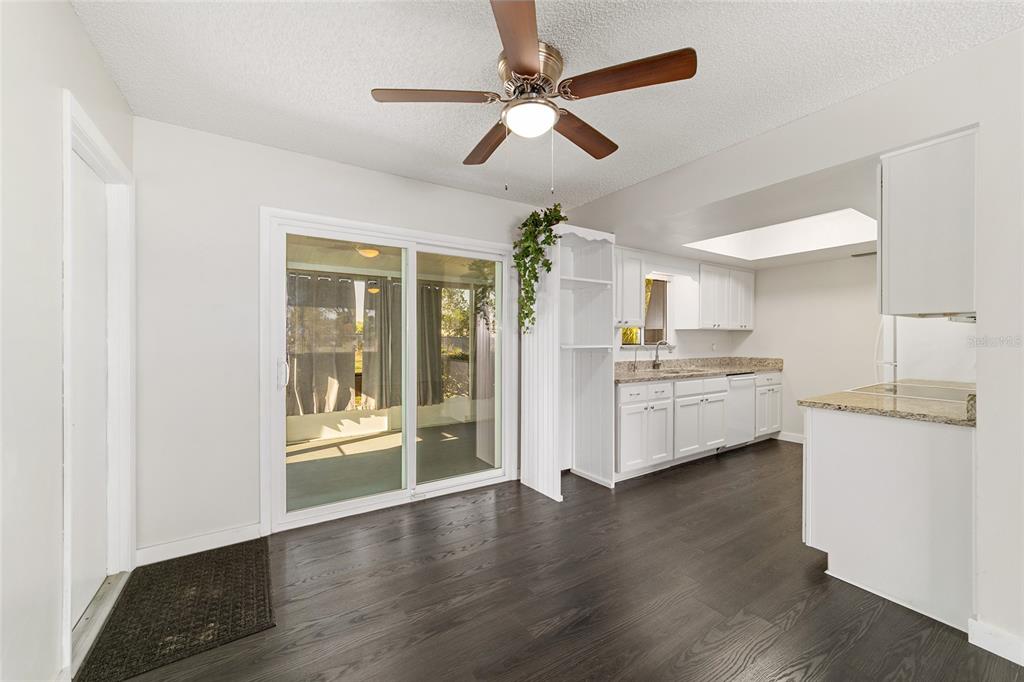 8329 Southwest 105th Place Ocala, FL 34481 - Photo 10 of 39 a view of a kitchen with a sink a refrigerator and a stove top oven