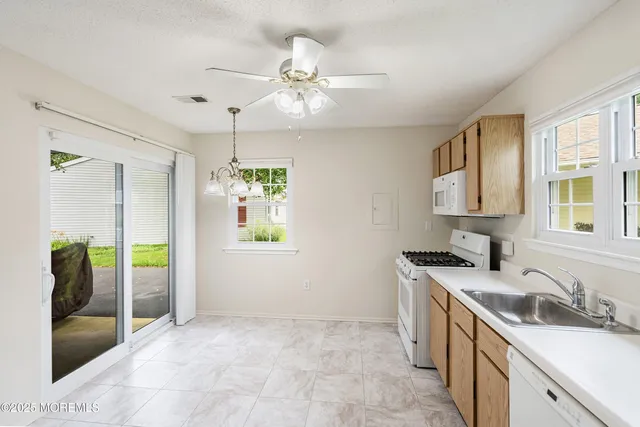 a kitchen with a sink stove and refrigerator
