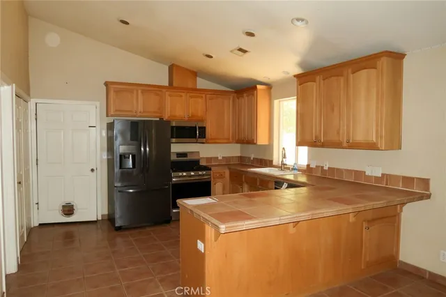 a kitchen with a refrigerator a stove and a sink