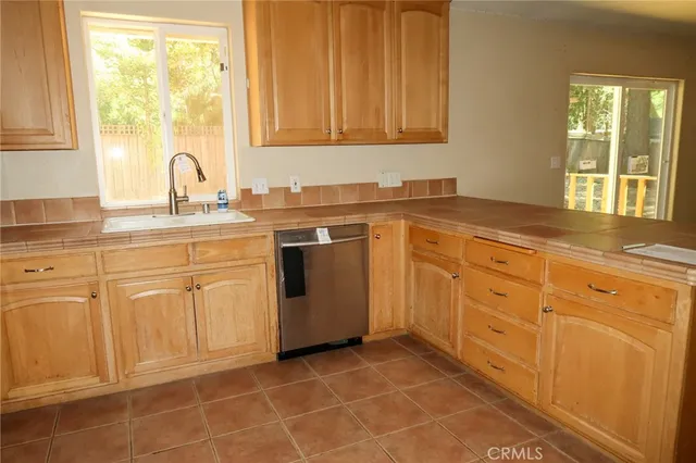 a kitchen with cabinets appliances and a window
