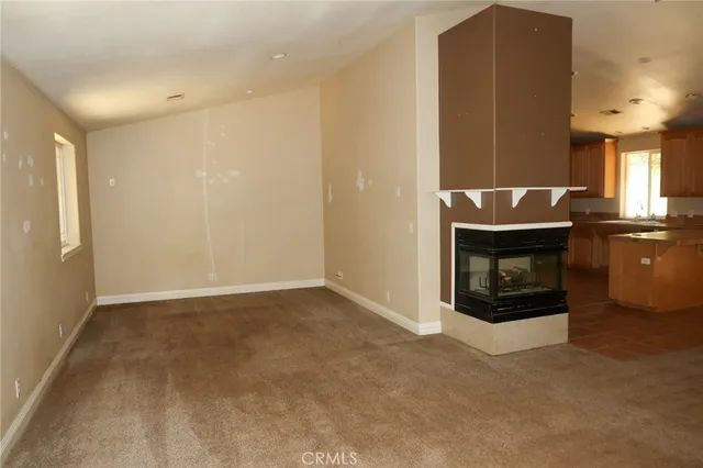 a view of an empty room with a fireplace
