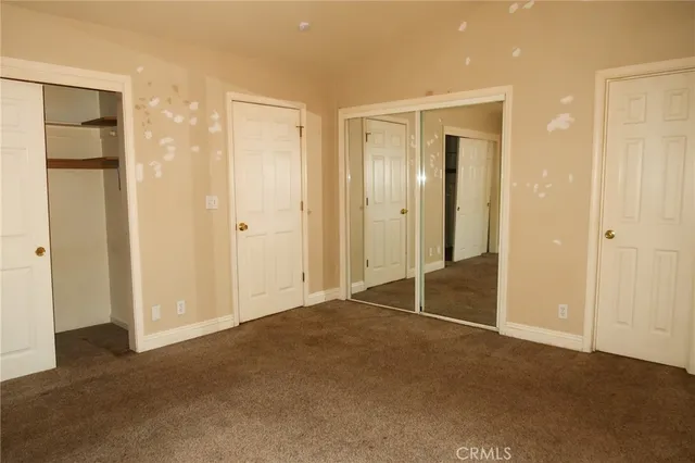 a view of an empty room with closet area