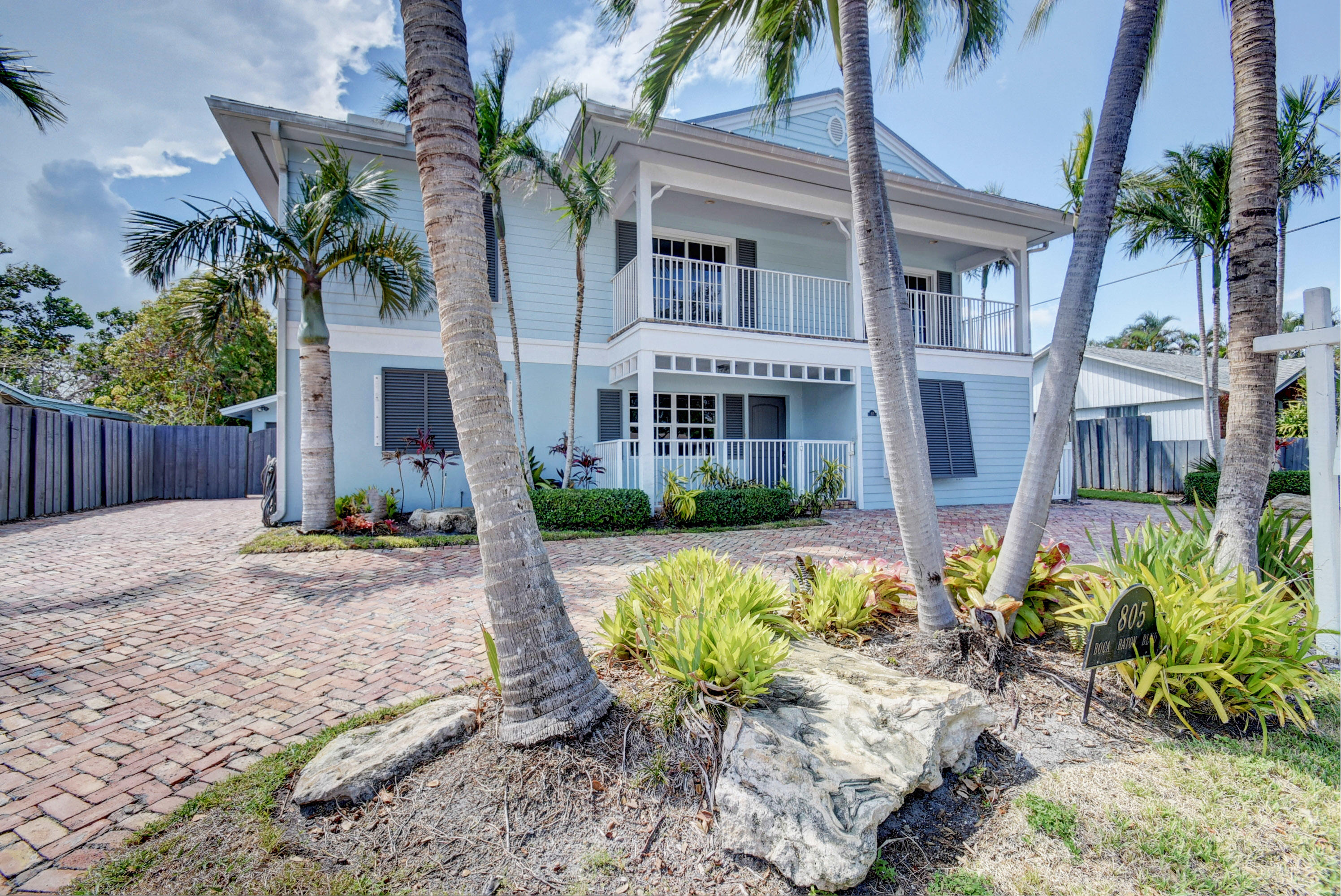 805 Northwest 2nd Avenue Boca Raton, FL 33432 - Photo 1 of 56 a front view of a house with a yard garden and outdoor seating