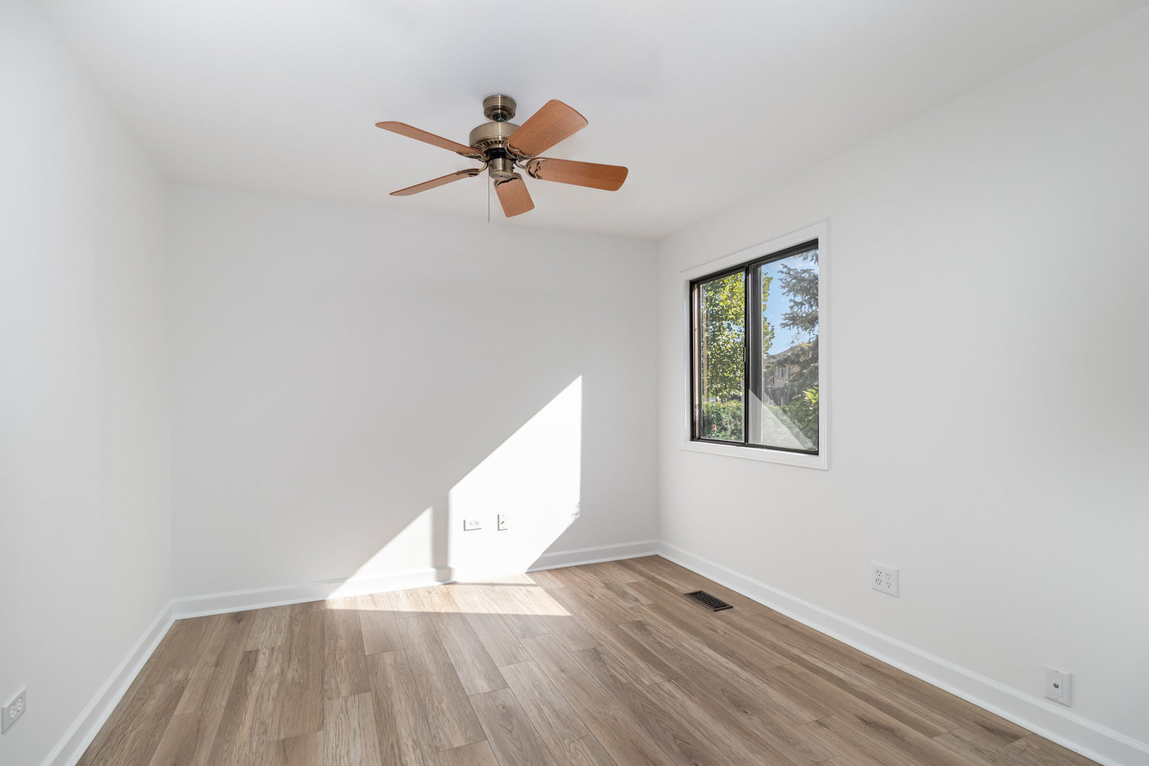 1467 Fairlane Drive, Unit 1B Schaumburg, IL 60193 - Photo 5 of 17 a view of empty room with wooden floor and fan