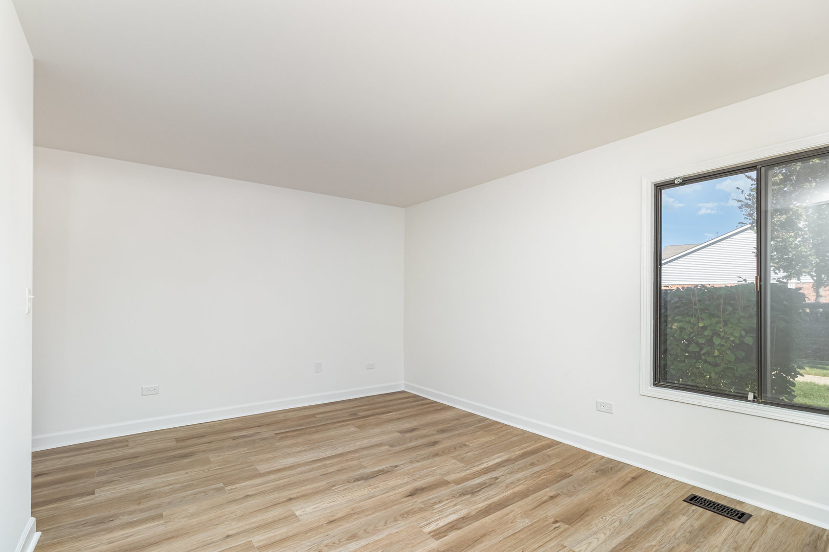 1467 Fairlane Drive, Unit 1B Schaumburg, IL 60193 - Photo 8 of 17 an empty room with wooden floor and windows