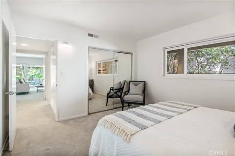 a spacious bedroom with a bed and a couch