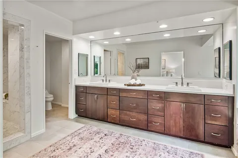 a bathroom with a double vanity sink mirror and