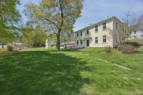 a front view of a building with a garden