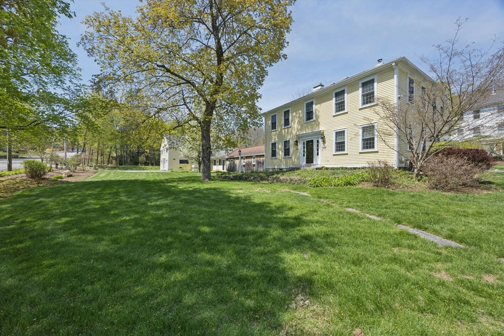 a front view of a building with a garden