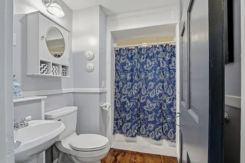 a bathroom with a toilet sink and shower