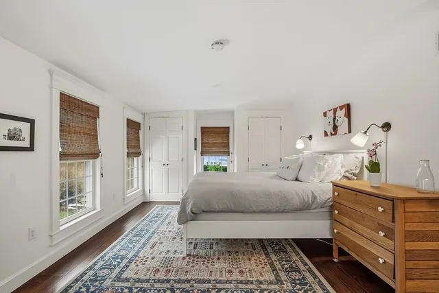 a spacious bedroom with a bed and a window