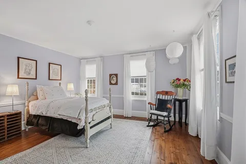 a bed room with a bed and a chair