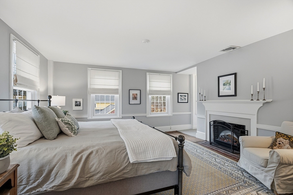 100 Main Street Ashburnham, MA 01430 - Photo 17 of 42 a spacious bedroom with a large bed and a fireplace